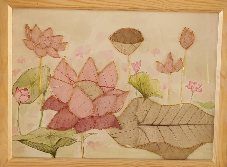 A framed picture of flowers and leaves

Description automatically generated