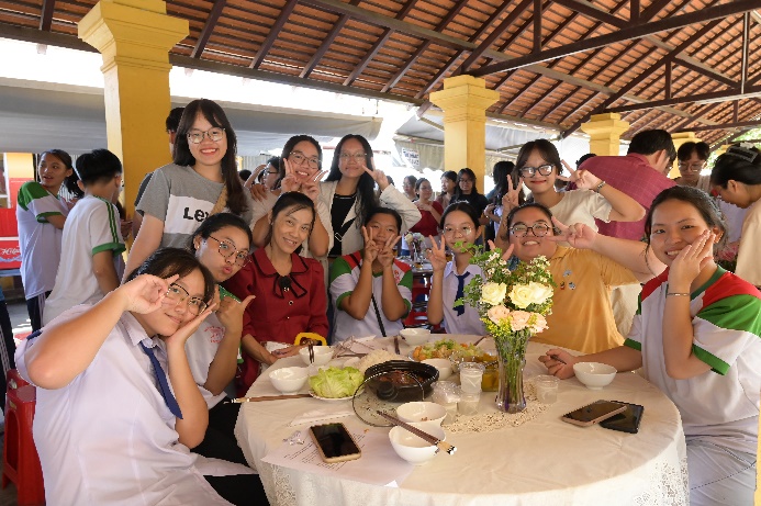 A group of people sitting around a table

Description automatically generated